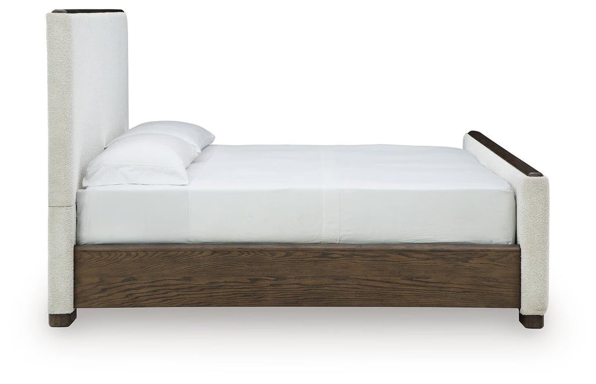 Radkin - Queen Upholstered Panel Bed - Burnished Brown