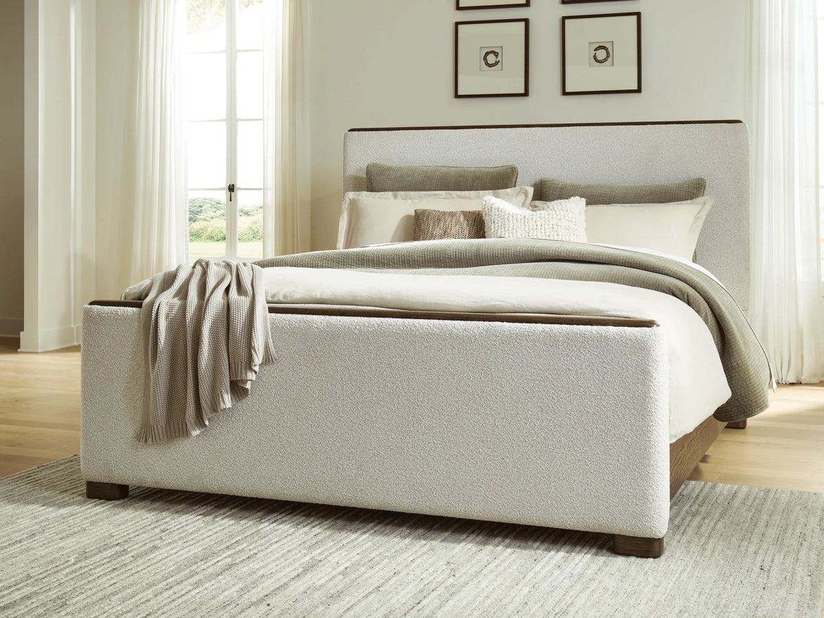 Radkin - Queen Upholstered Panel Bed - Burnished Brown